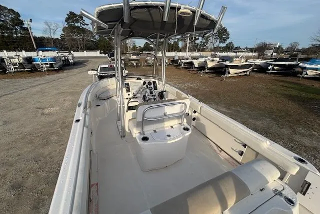 Slide: The Image of 2014 Robalo R222 Center Console boat with spacious deck and seating, parked outdoors. - 9