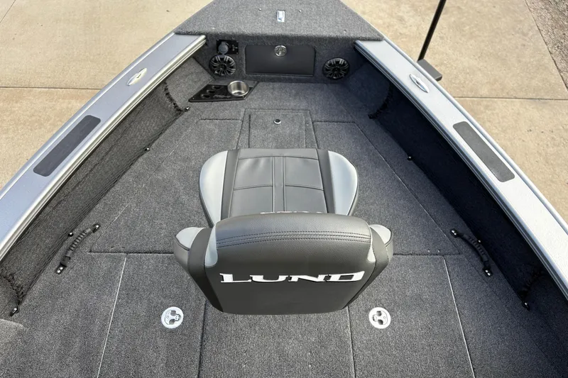 Slide: The Image of 2026 Lund 1975 Pro-V Sport boat interior with gray seating and carpeted deck. - 10