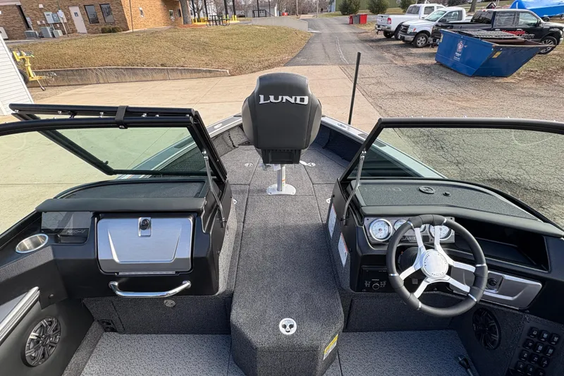 Slide: The Image of Interior view of 2026 Lund 1975 Pro-V Sport boat, featuring steering wheel and seating. - 17