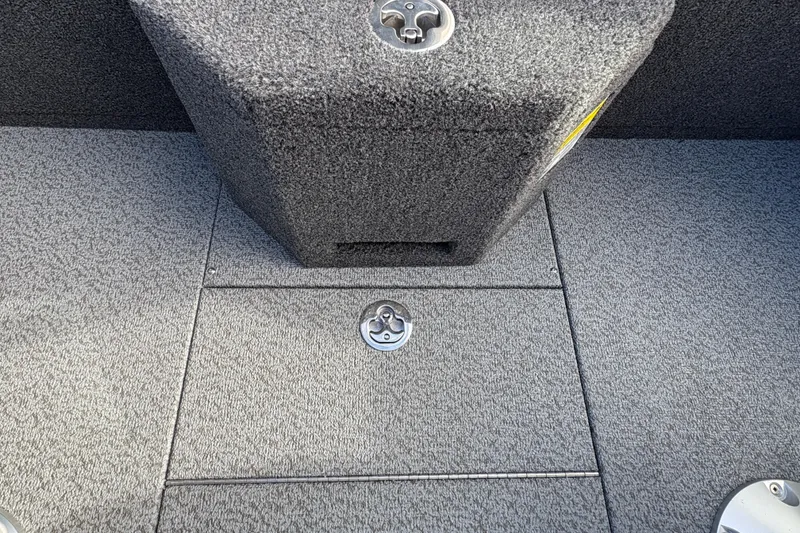 Slide: The Image of Interior of 2026 Lund 1975 Pro-V Sport boat with carpeted flooring and storage compartment. - 20