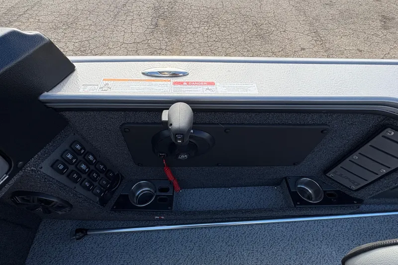 Slide: The Image of Control panel of 2026 Lund 1975 Pro-V Sport boat with switches and cup holders. - 26