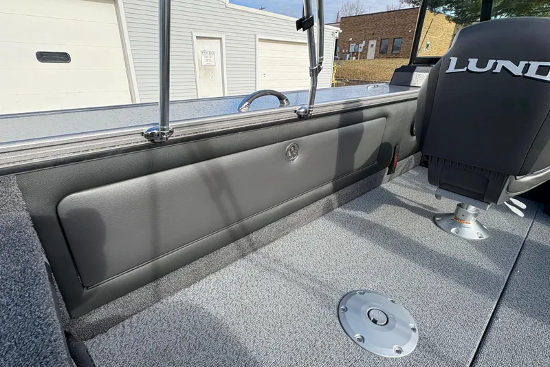 Slide: The Image of 2026 Lund 1975 Pro-V Sport boat interior with gray seating and carpeted flooring. - 31