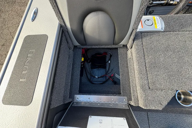 Slide: The Image of Interior view of 2026 Lund 1975 Pro-V Sport boat, showcasing storage compartment and wiring. - 39