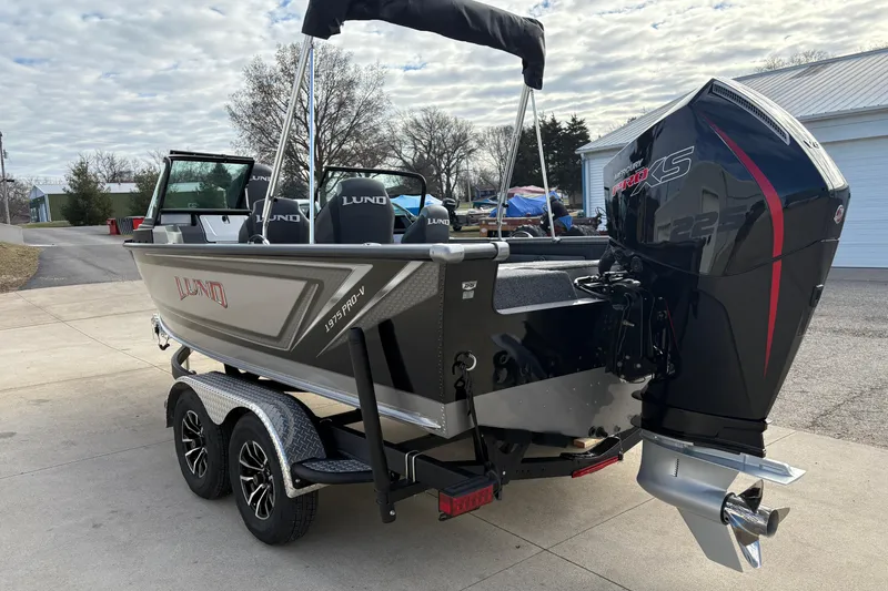 Slide: The Image of 2026 Lund 1975 Pro-V Sport boat with powerful outboard motor on a trailer. - 4