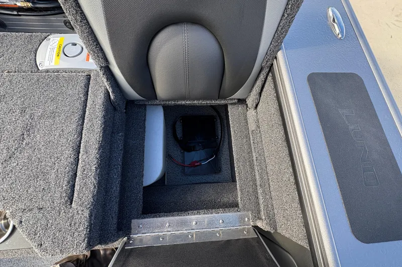 Slide: The Image of Interior view of 2026 Lund 1975 Pro-V Sport boat, featuring storage compartment and seating. - 41