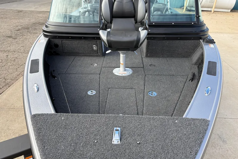 Slide: The Image of 2026 Lund 1975 Pro-V Sport boat interior with seating and carpeted deck. - 9