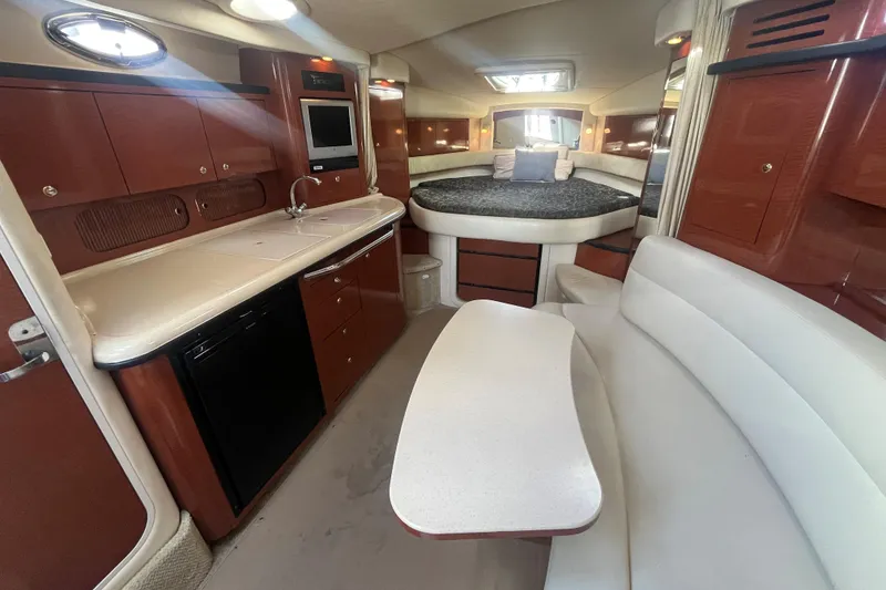 Slide: The Image of Luxurious interior of 2004 Sea Ray 340 Sundancer yacht with kitchen and seating area. - 13
