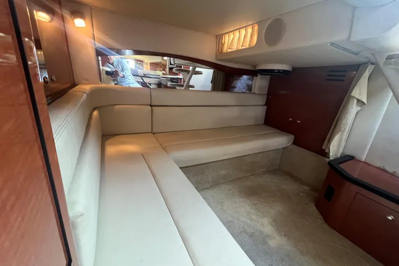 Slide: The Image of Interior of 2004 Sea Ray 340 Sundancer yacht with beige seating and wood accents. - 15