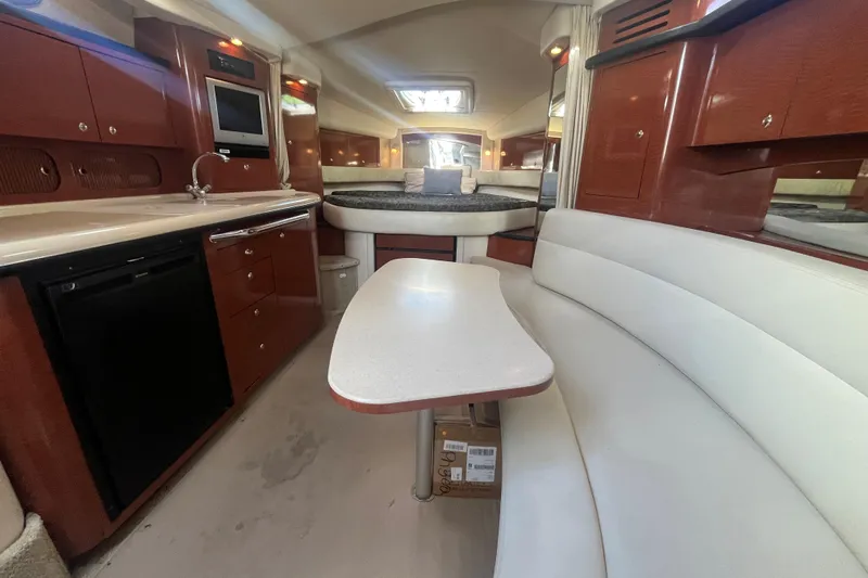 Slide: The Image of Interior of 2004 Sea Ray 340 Sundancer yacht with kitchen and seating area. - 20