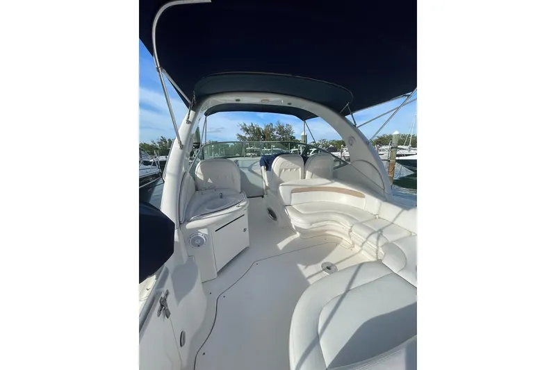 Slide: The Image of 2004 Sea Ray 340 Sundancer boat interior with white seating and canopy. - 21