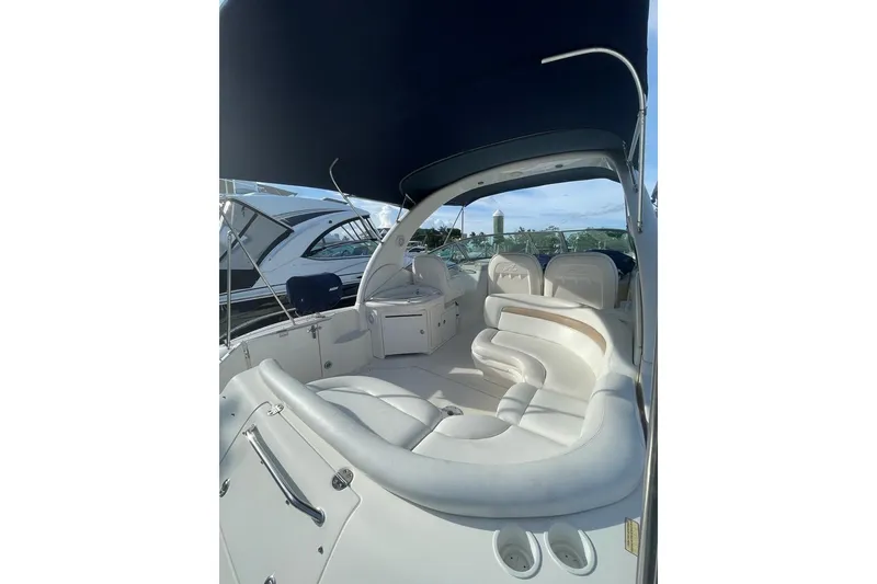 Slide: The Image of 2004 Sea Ray 340 Sundancer boat interior with white seating and canopy. - 22