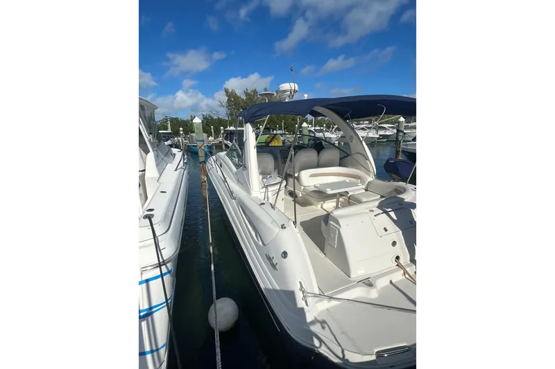 Slide: The Image of 2004 Sea Ray 340 Sundancer docked under clear blue sky. - 4