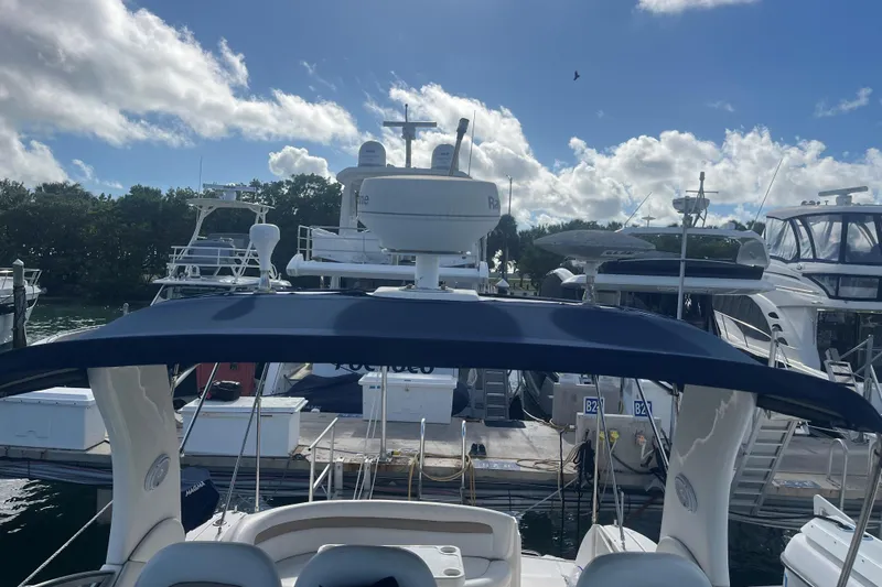 Slide: The Image of 2004 Sea Ray 340 Sundancer docked at marina under blue sky. - 8