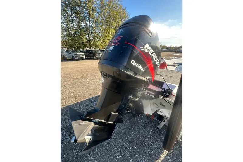 Slide: The Image of 2004 Bumble Bee Pro Vee XT with Mercury OptiMax outboard motor in a parking lot. - 12