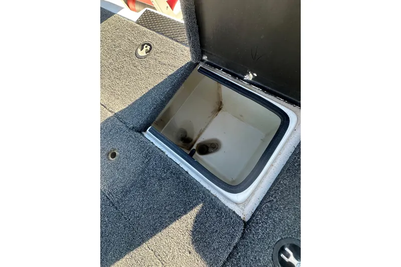 Slide: The Image of Open storage compartment in 2004 Bumble Bee Pro Vee XT boat. - 16