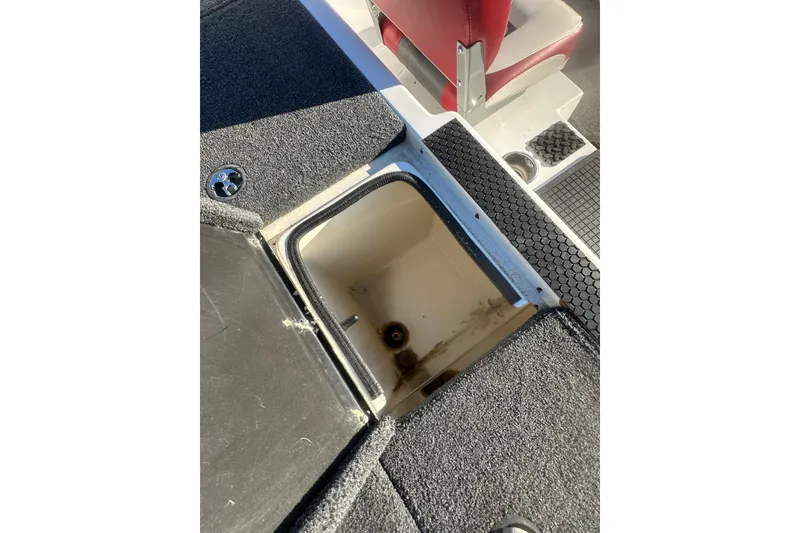 Slide: The Image of Open storage compartment on 2004 Bumble Bee Pro Vee XT boat deck. - 17