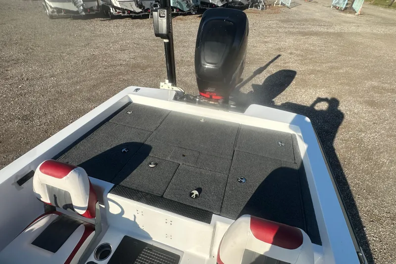 Slide: The Image of 2004 Bumble Bee Pro Vee XT boat with motor, featuring red and white seating. - 22