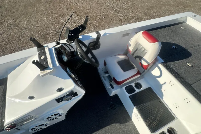 Slide: The Image of 2004 Bumble Bee Pro Vee XT boat interior with steering wheel and cushioned seat. - 23