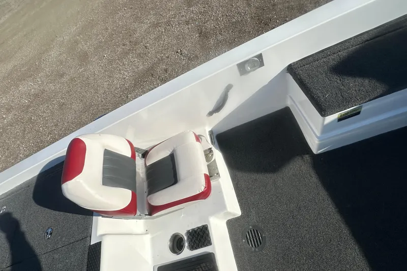 Slide: The Image of 2004 Bumble Bee Pro Vee XT boat interior with red and white seating. - 24