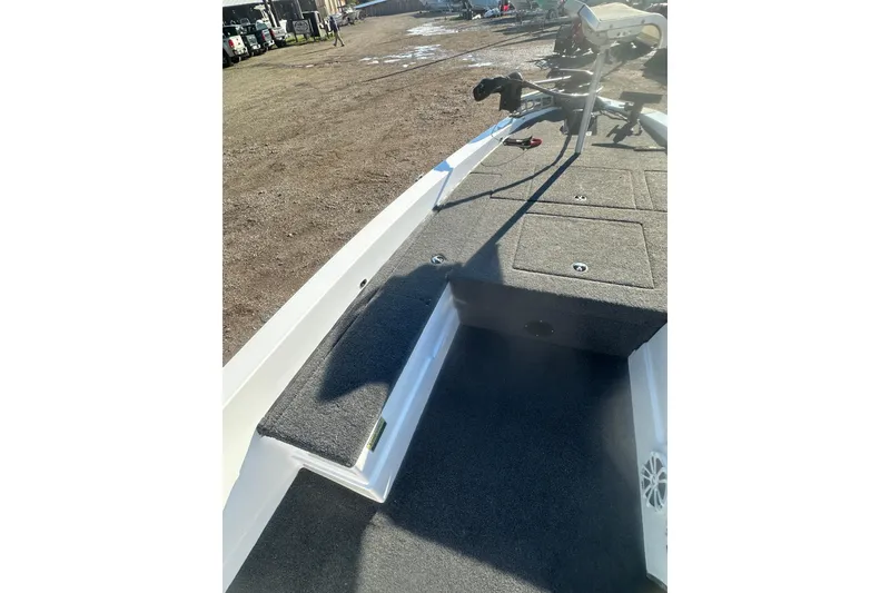 Slide: The Image of 2004 Bumble Bee Pro Vee XT boat interior with carpeted deck and seating area. - 25