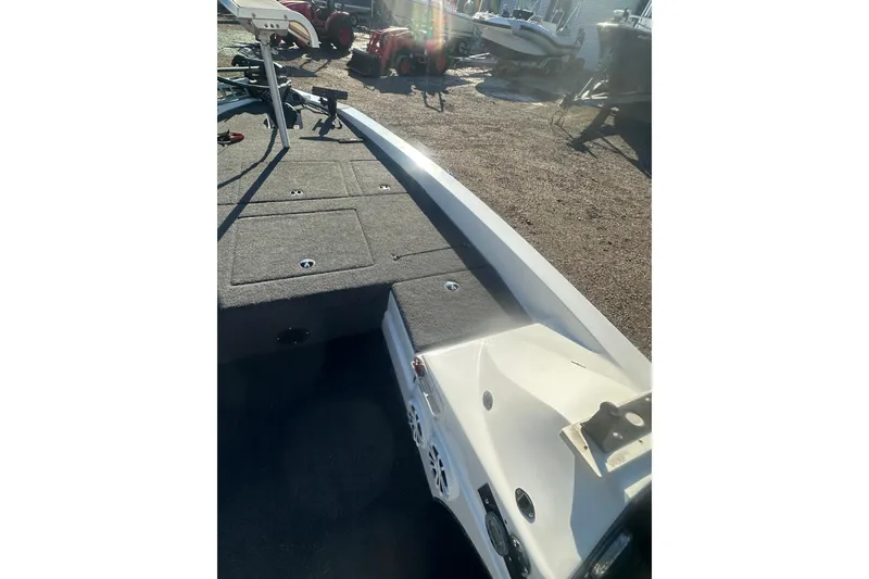 Slide: The Image of 2004 Bumble Bee Pro Vee XT boat deck with storage compartments and equipment. - 26