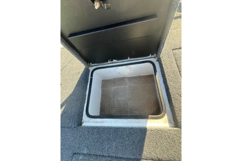 Slide: The Image of Open storage compartment in 2004 Bumble Bee Pro Vee XT boat. - 30
