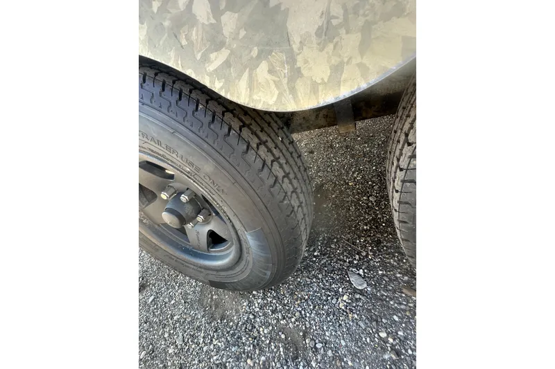 Slide: The Image of Close-up of 2004 Bumble Bee Pro Vee XT trailer tires on gravel. - 35