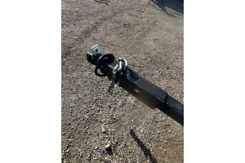 Slide: The Image of Trailer hitch of a 2004 Bumble Bee Pro Vee XT on gravel surface. - 36