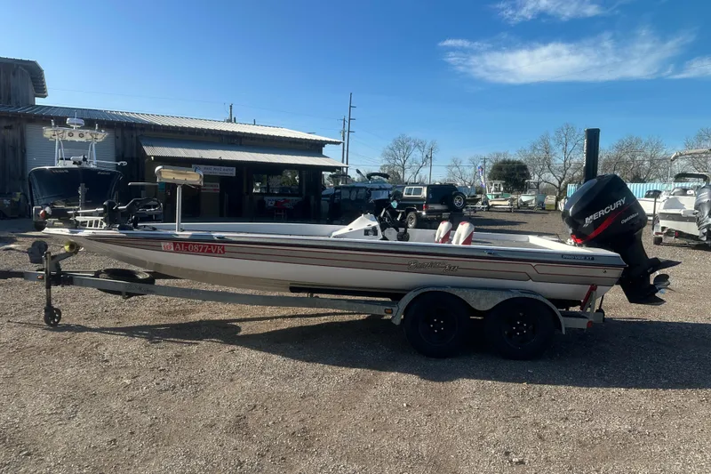 Slide: The Image of 2004 Bumble Bee Pro Vee XT boat with Mercury outboard motor in a boatyard. - 46