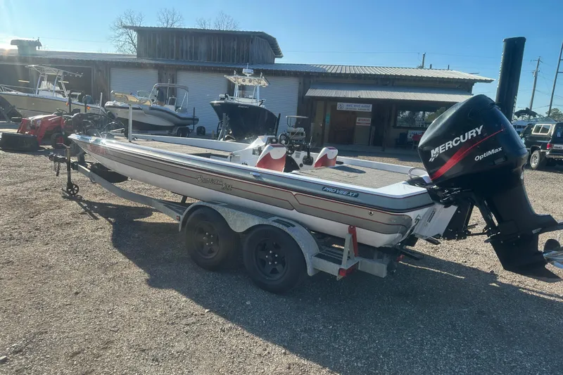 Slide: The Image of 2004 Bumble Bee Pro Vee XT boat with Mercury Optimax engine on trailer. - 47