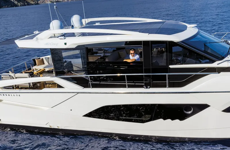 Slide: The Image of 2024 Absolute 48 Coupe luxury yacht cruising on the ocean. - 4