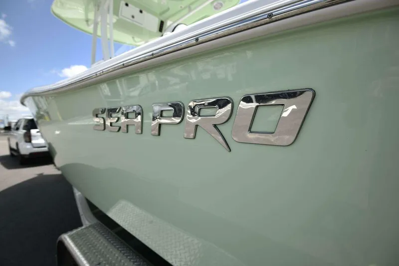Slide: The Image of 2023 Sea Pro 239 Center Console boat displayed outdoors at a dealership. - 13