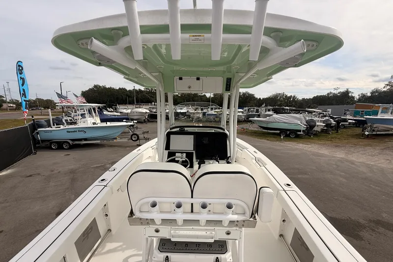 Slide: The Image of 2023 Sea Pro 239 Center Console boat at a dealership, showcasing helm and seating area. - 16