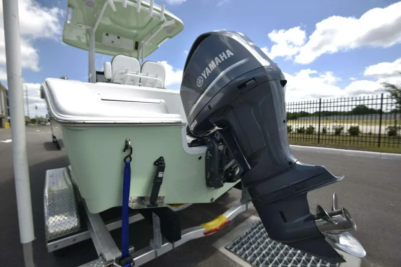 Slide: The Image of 2023 Sea Pro 239 Center Console storage compartment with warning labels and capacity information. - 21