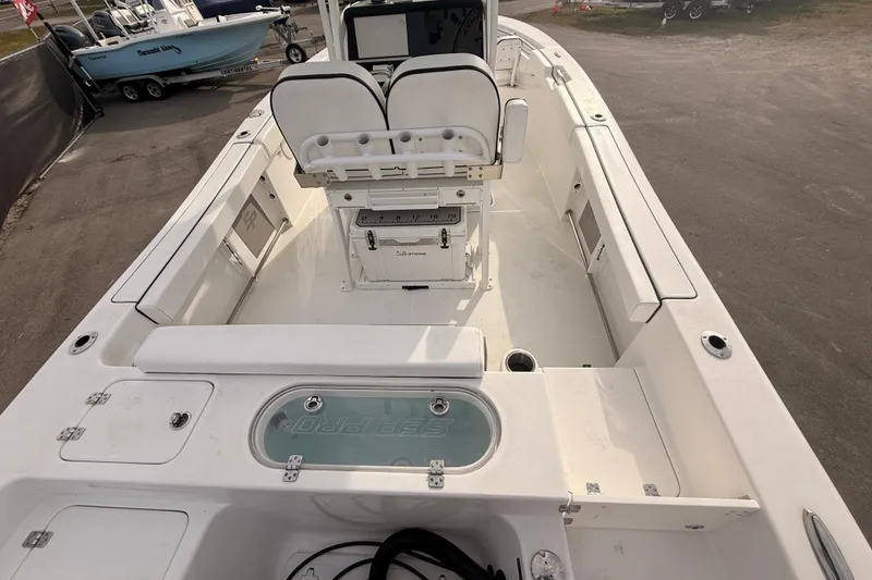 Slide: The Image of Steering wheel of 2023 Sea Pro 239 Center Console boat, featuring control panel. - 24