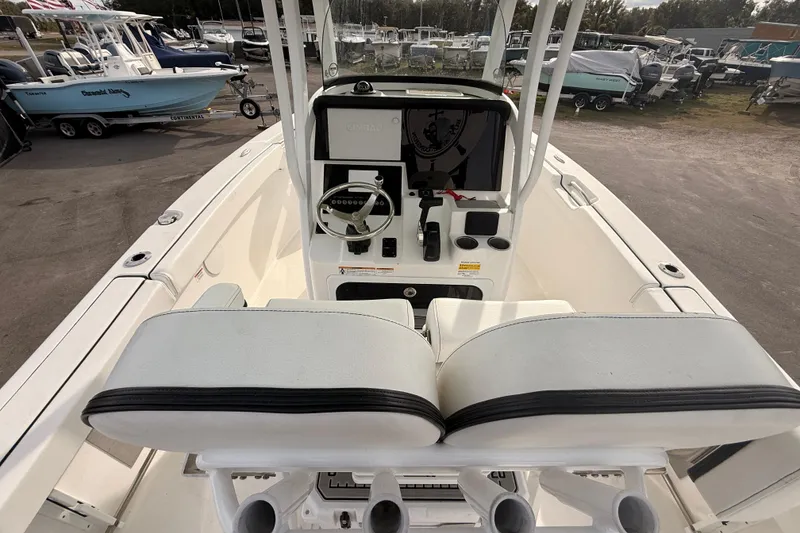 Slide: The Image of 2023 Sea Pro 239 Center Console boat dashboard with compass, docked among other boats. - 29
