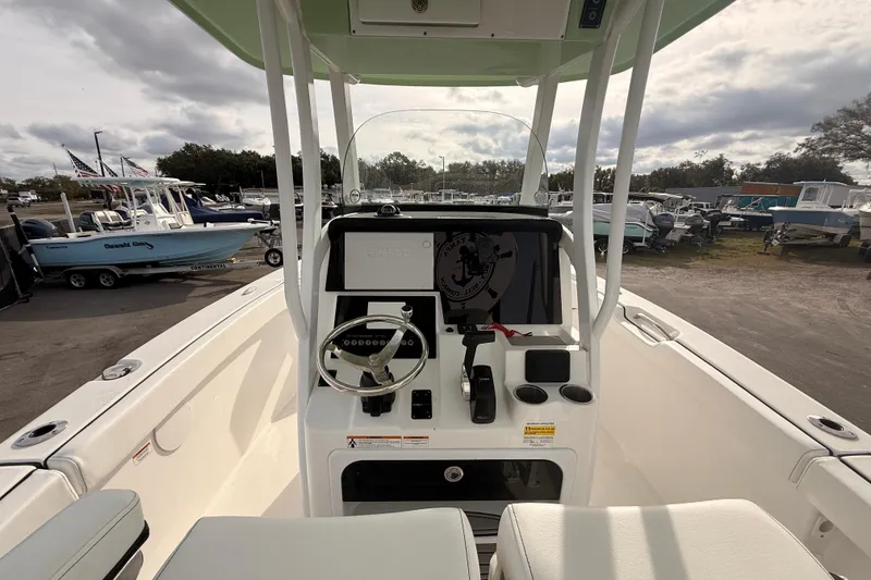 Slide: The Image of 2023 Sea Pro 239 Center Console boat interior with open storage compartment and compass. - 30