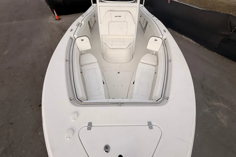 Slide: The Image of 2023 Sea Pro 239 Center Console boat interior with open storage compartment and cushioned seating. - 43