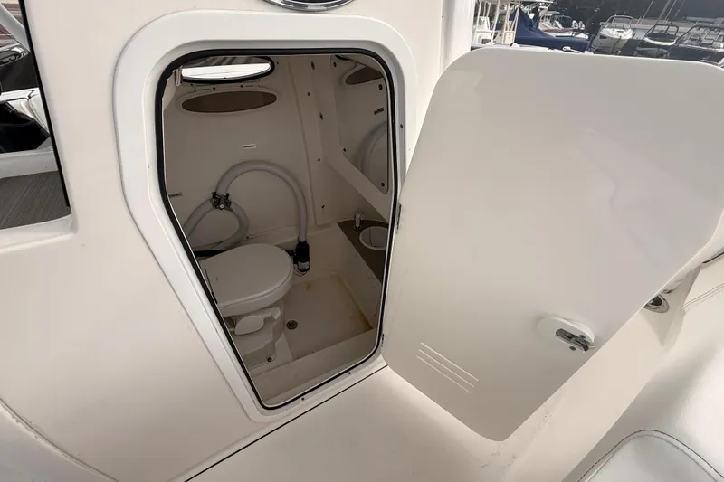 Slide: The Image of 2023 Sea Pro 239 Center Console boat storage compartment with open lid. - 48
