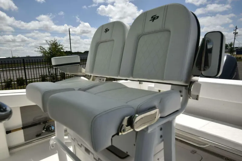 Slide: The Image of 2023 Sea Pro 239 Center Console boat interior with white seating and logo. - 50