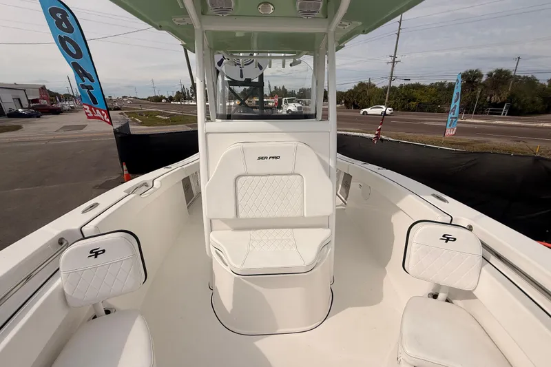 Slide: The Image of 2023 Sea Pro 239 Center Console boat interior with seating and console view. - 57