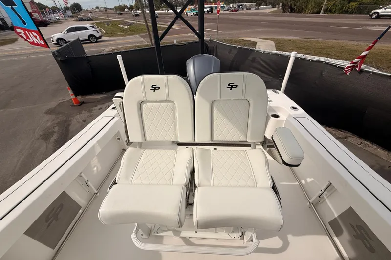 Slide: The Image of 2023 Sea Pro 239 Center Console boat with dual white cushioned seats. - 58