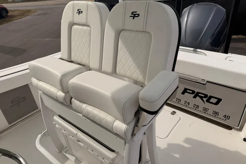 Slide: The Image of 2023 Sea Pro 239 Center Console boat with white cushioned seating and armrests. - 60