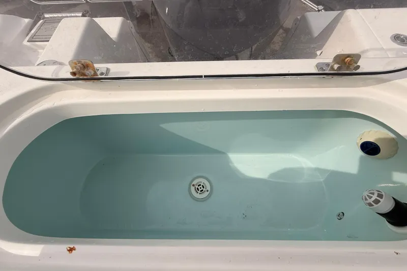 Slide: The Image of Livewell on 2023 Sea Pro 239 Center Console boat, filled with water. - 64