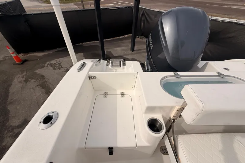Slide: The Image of 2023 Sea Pro 239 Center Console boat interior with engine and seating area. - 65