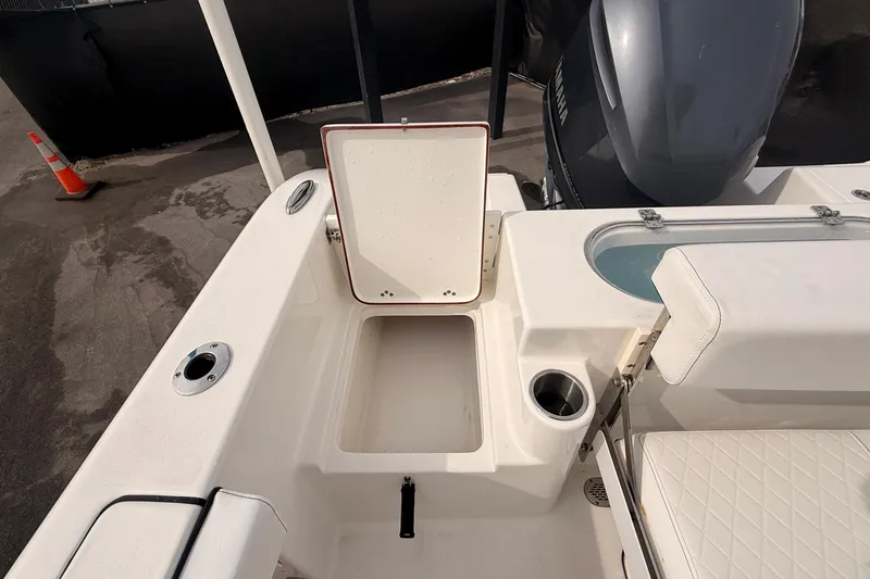 Slide: The Image of 2023 Sea Pro 239 Center Console boat interior with open storage compartment and seating. - 66