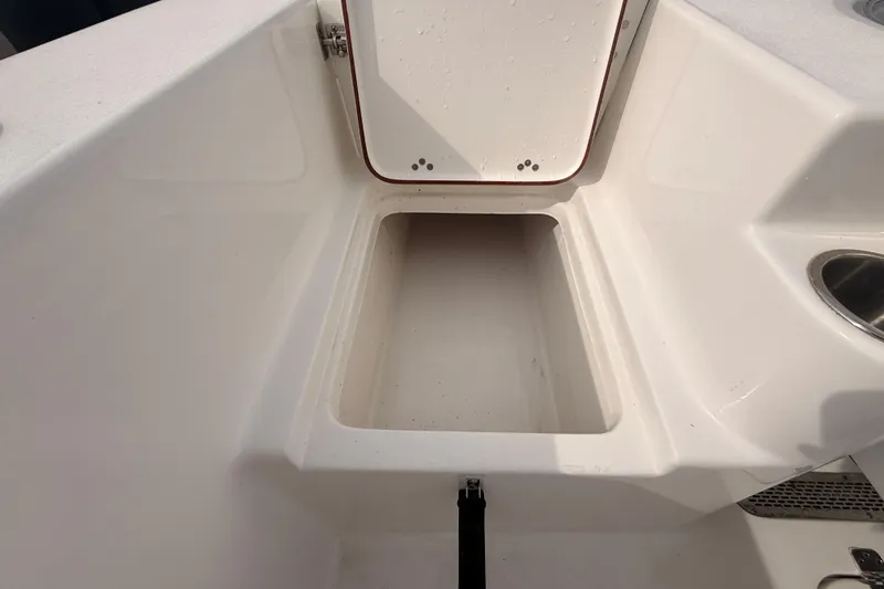 Slide: The Image of 2023 Sea Pro 239 Center Console storage compartment with open hatch. - 67