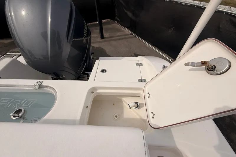 Slide: The Image of 2023 Sea Pro 239 Center Console boat with open storage compartments and engine view. - 69