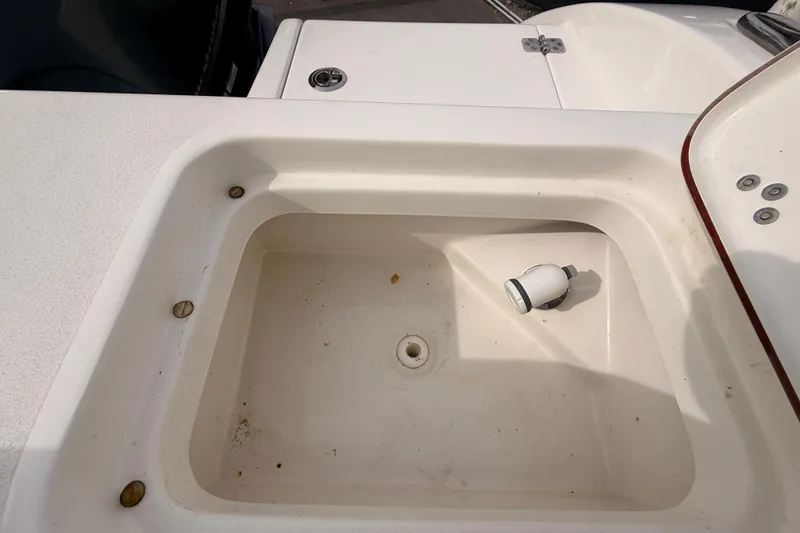 Slide: The Image of 2023 Sea Pro 239 Center Console boat sink with faucet and drainage. - 70