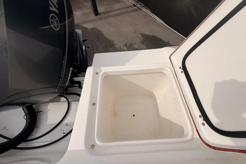 Slide: The Image of 2023 Sea Pro 239 Center Console boat with open storage compartment and Yamaha engine. - 72